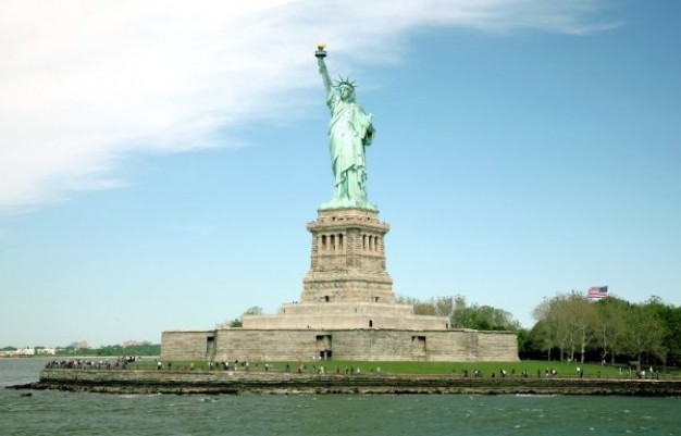 statue of liberty ps matting with original over blue sky and clouds