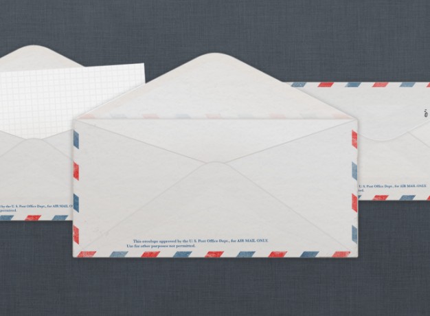 vintage us air mail envelope over dark blue background