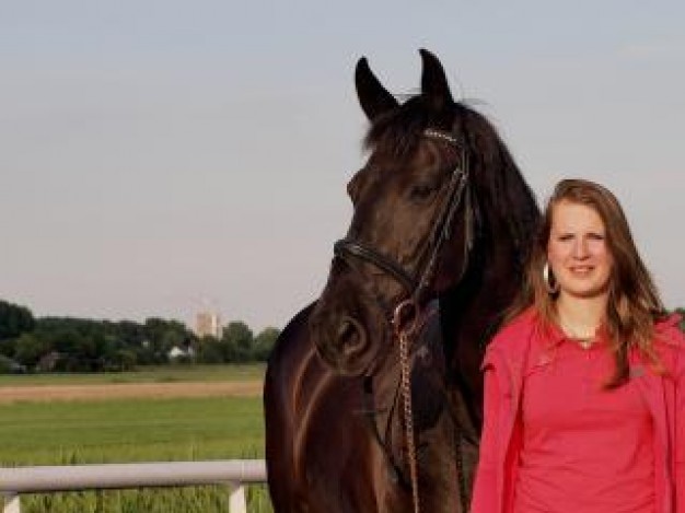 girl and her horse standing at nature road