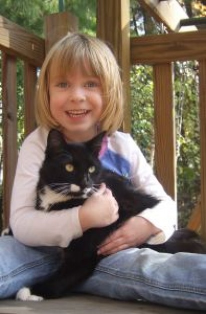 girl loves black cat in wood carridor