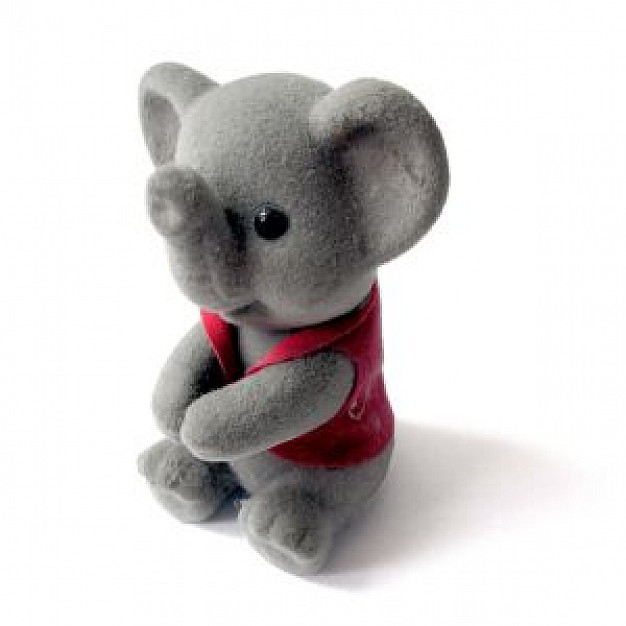 gray elephant toy sitting in white surface