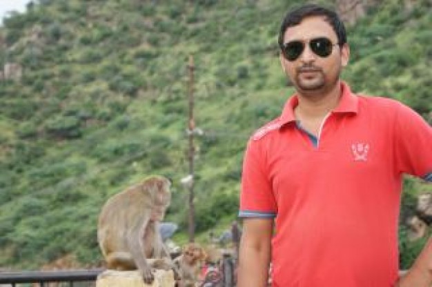 India Man with Red Shirt and mountain at back