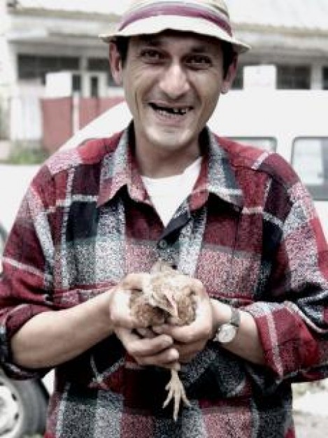 Smile humane man with hat hanging with Chicken