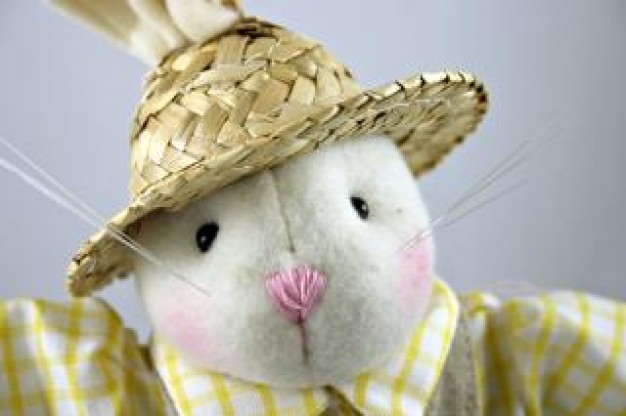 white easter rabbit toy with a grass hat