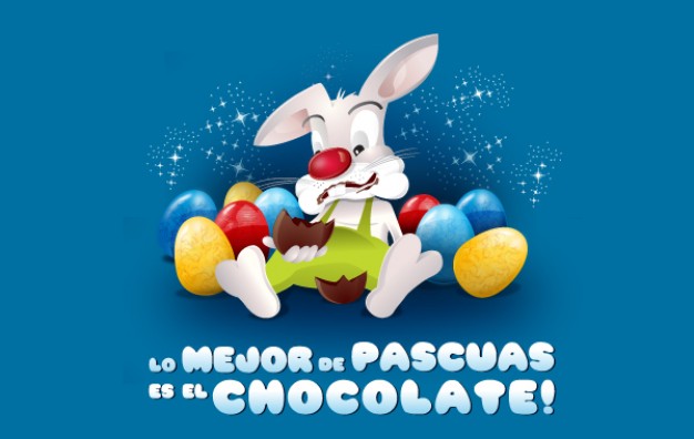 white rabbit sitting in chocolate egg stack over blue background